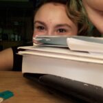 Maiah at Maryville College January 24, 2020 with stack of homework
